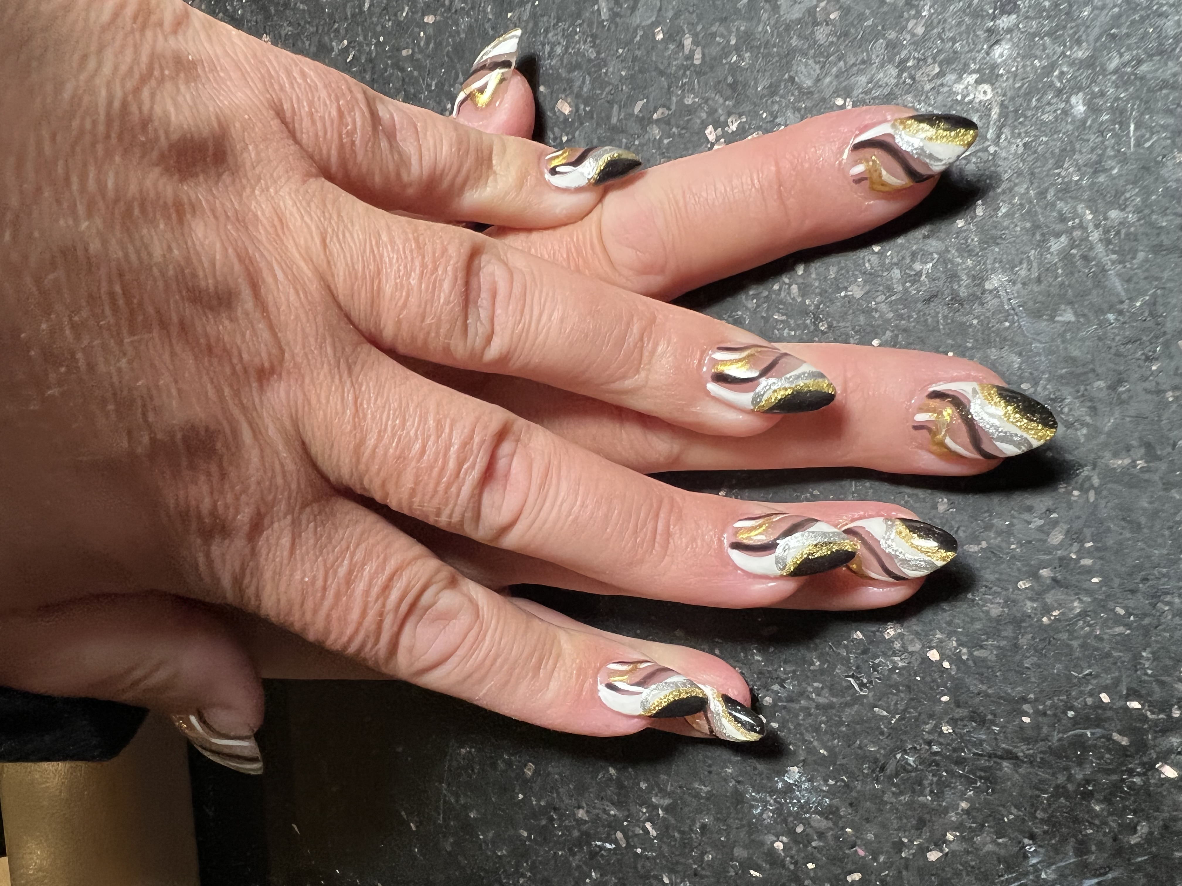 Gold and black swirl nails